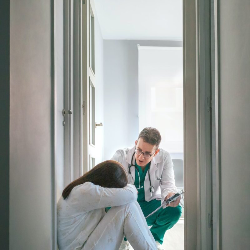 psychiatrist-talking-to-patient-sitting-on-the-floor-in-a-mental-health-center.jpg